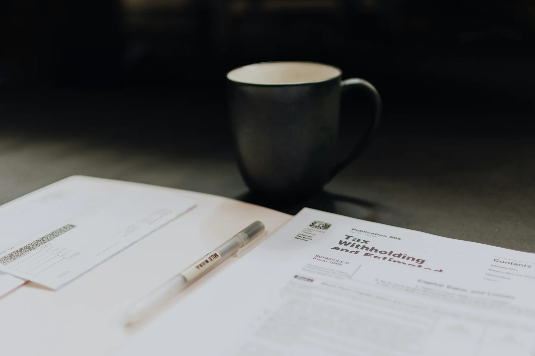 Tax documents and pen on a desk