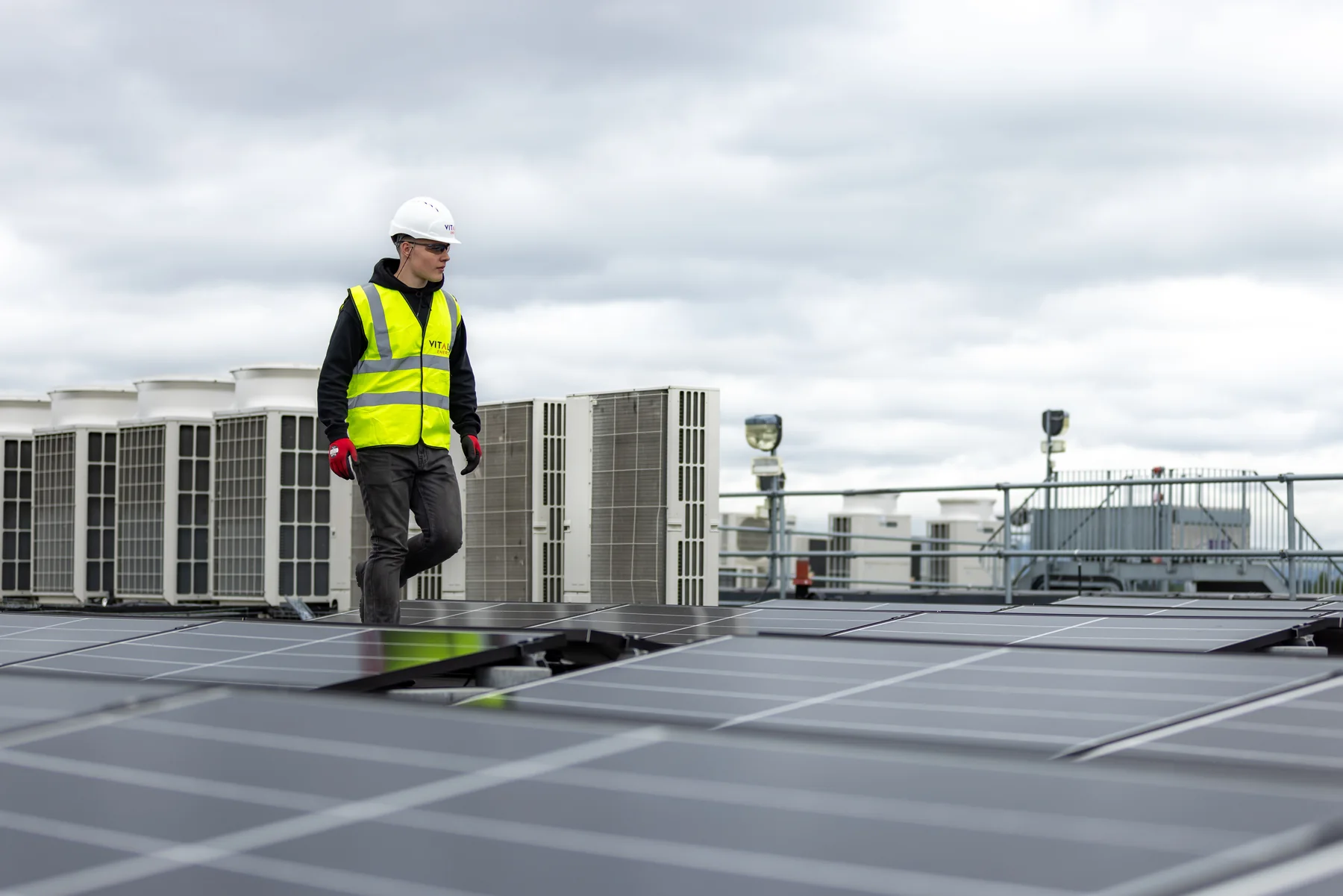 Solar worker inspecting a commercial rooftop array